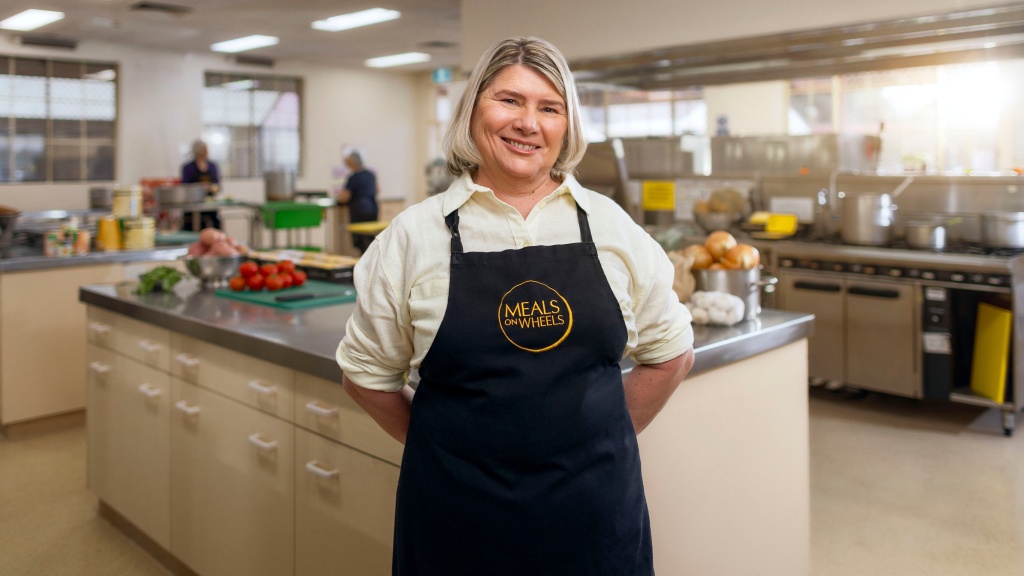 Chef volunteer in kitchen for meals on wheels recruitment commercial.