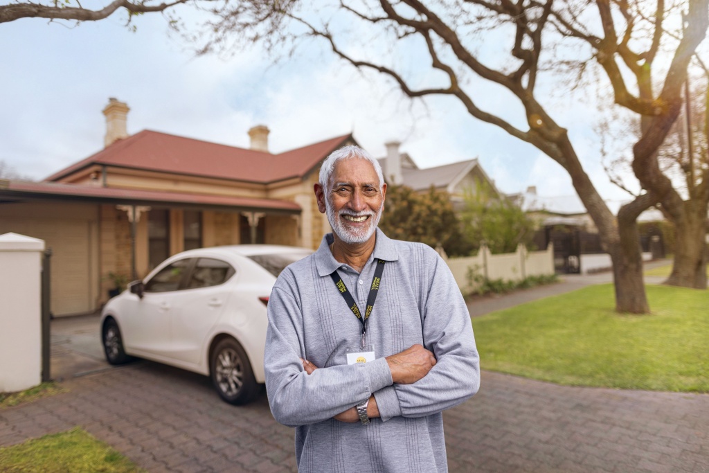 Man standing in front of car for authentic marketing campaign.