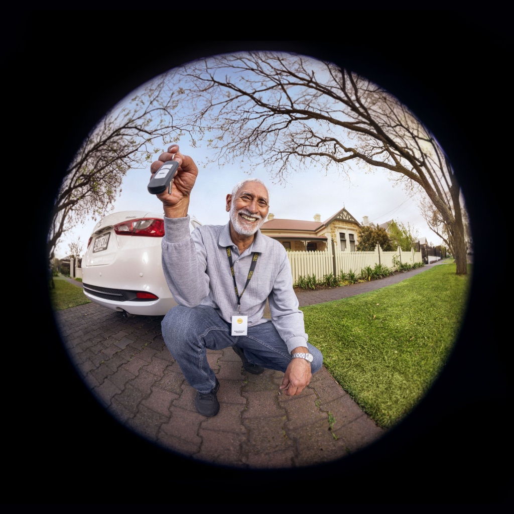 driver holding keys and smiling as a part of Adelaide's best tv commercial.