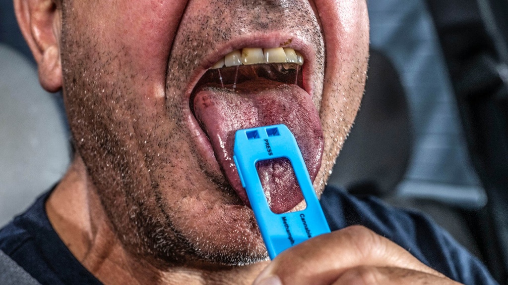 Tongue taking drug driving test for behaviour change campaign.