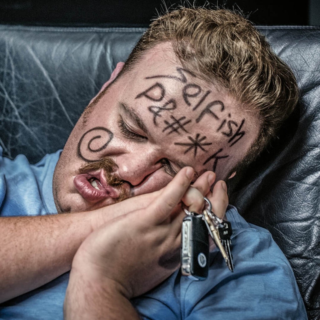 Drunk guy sleeping with keys in hand for social execution of behaviour change campaign.
