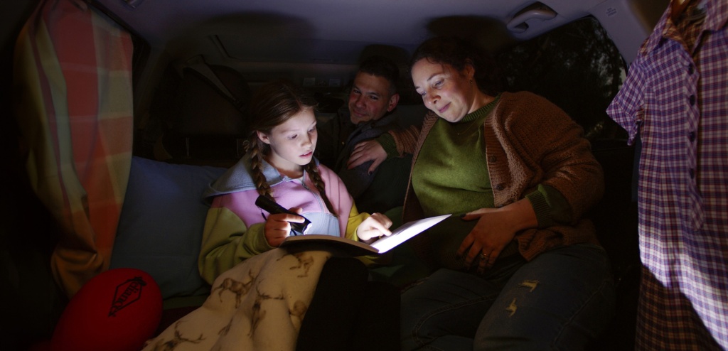 Family reading in car for social media video content.