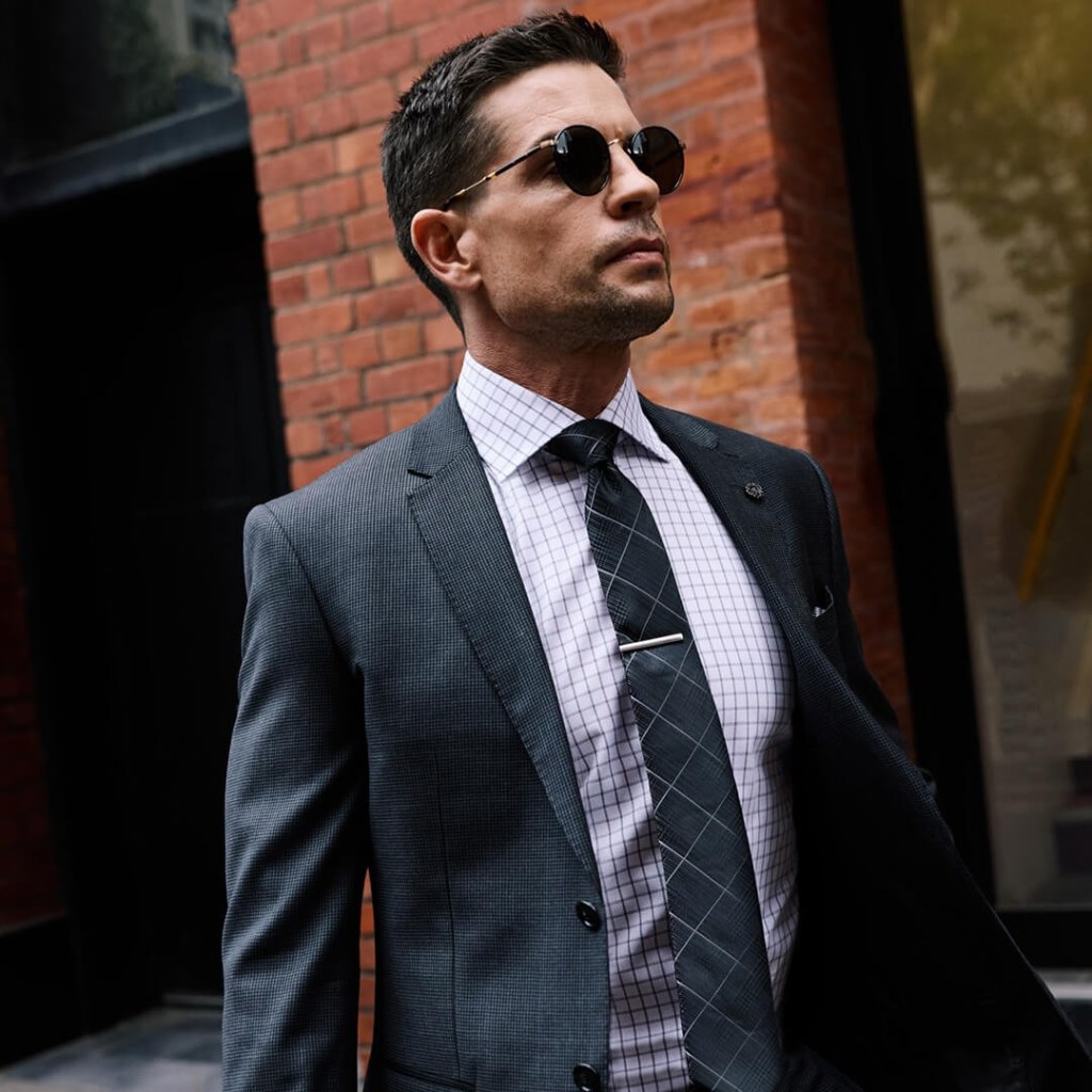 Man in suit and check shirt for brand positioning campaign.