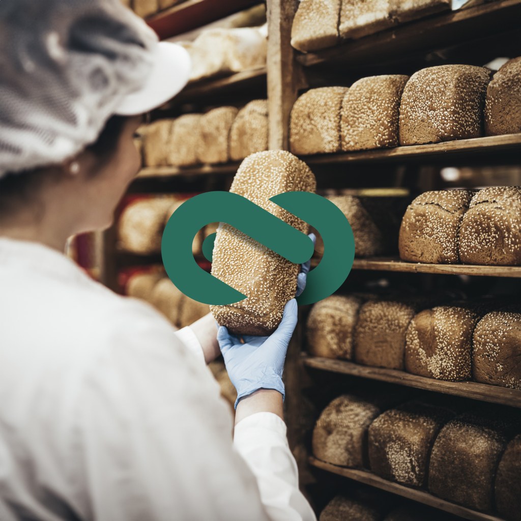 Woman holding bread with logo mark as a part of the brand suite.