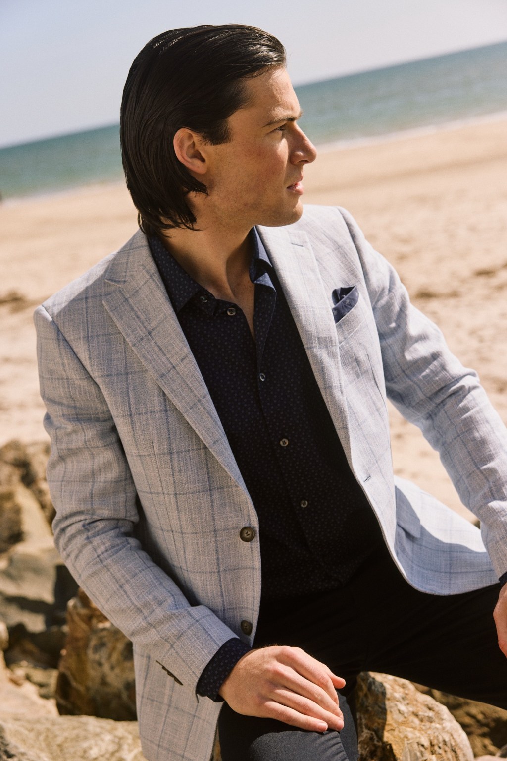 Man in light blue suit for ad creative.