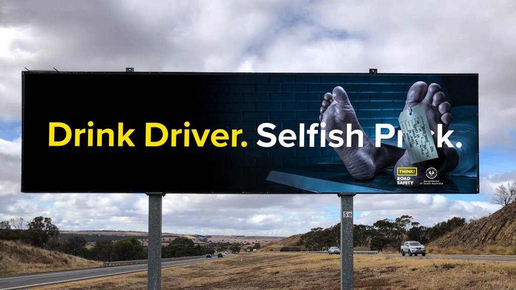 Billboard of a dead persons feet on a morgue table for SAPOL drink driving behaviour change campaign.